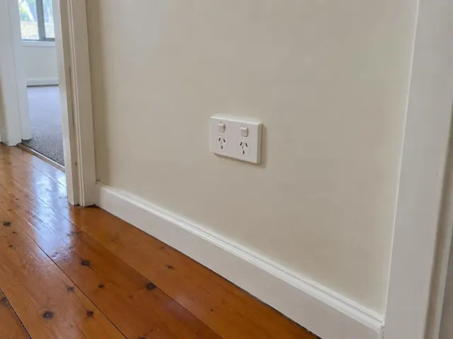 Double power point on a cream hallway wall above white skirting in a home in Beresfield